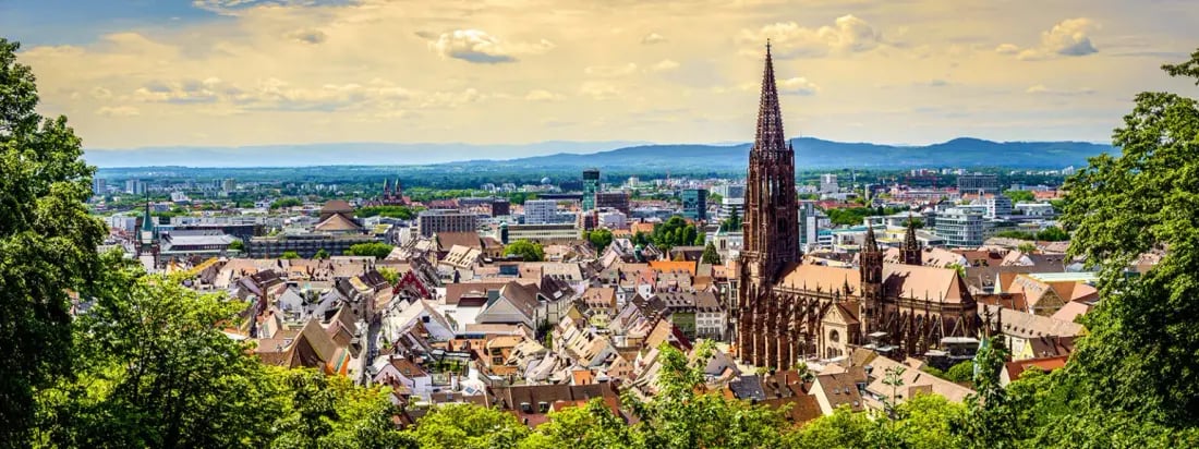 Freiburg im Breisgau seen across the old town toward the Münster spire and the Black Forest